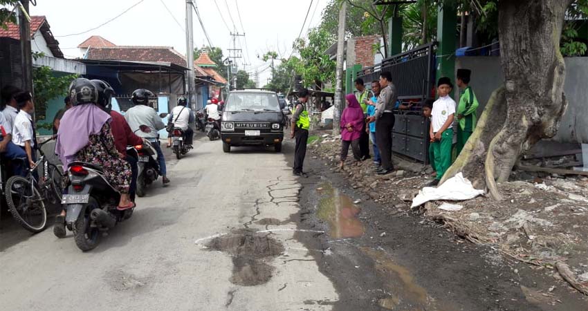 OLAH TKP - Sejumlah petugas Unit Laka, Satuan Lantas, Polresta Sidoarjo menggelar olah TKP tewasnya pengendara motor Yamaha Mio bernopol P 3820 VG, Nuri Wulandari (40) warga Pondok Benowo Indah Blok ES 17, Kelurahan Babat, Kecamatan Pakal, Surabaya, Senin (16/12/2019)